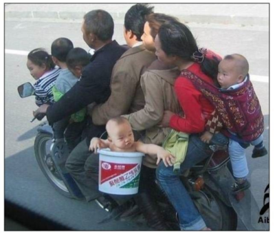 Nine family members (4 children) on one scooter One in bucket and one in backpack