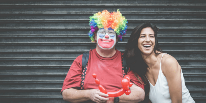 Clown and young lady smiling