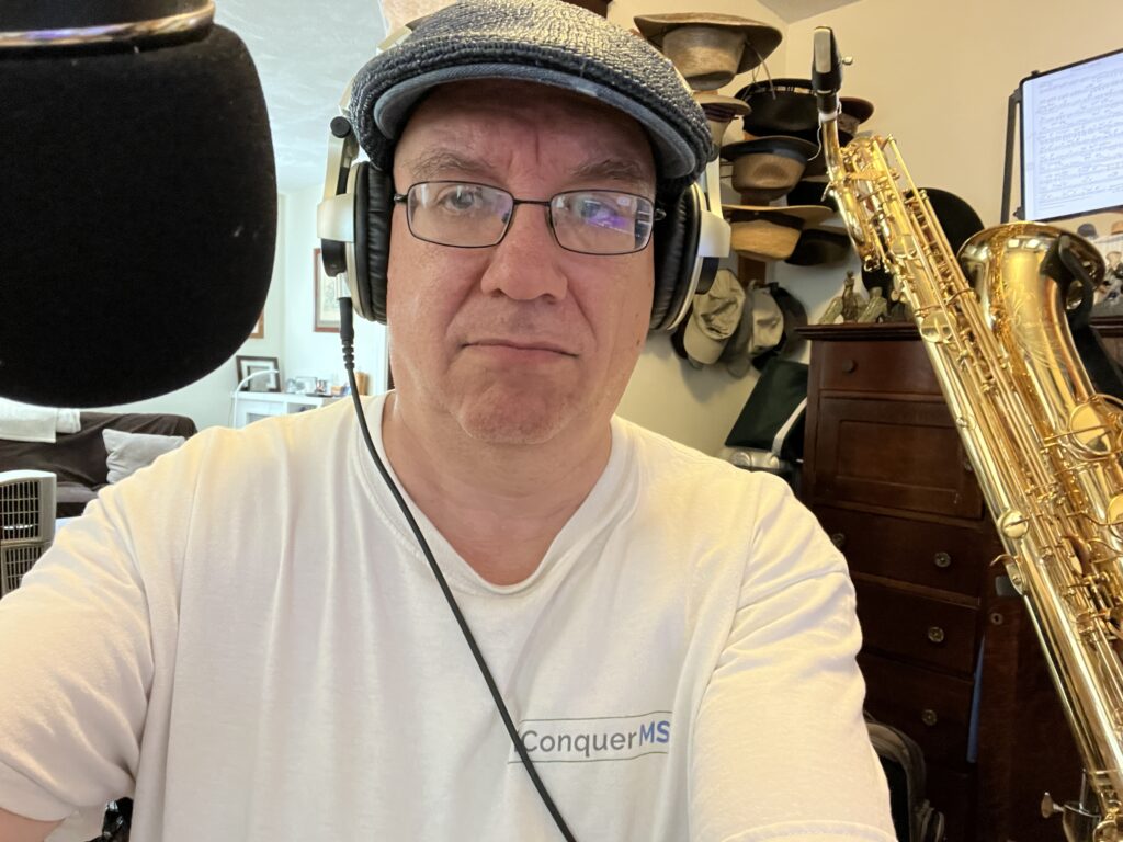 Man with glasses, headphones, and horn