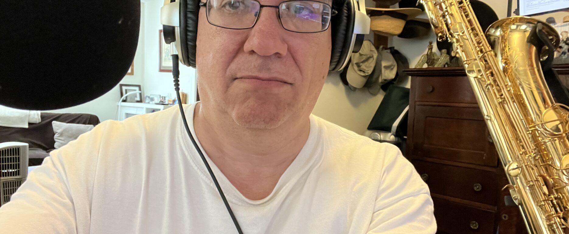 Man with glasses, headphones, and horn