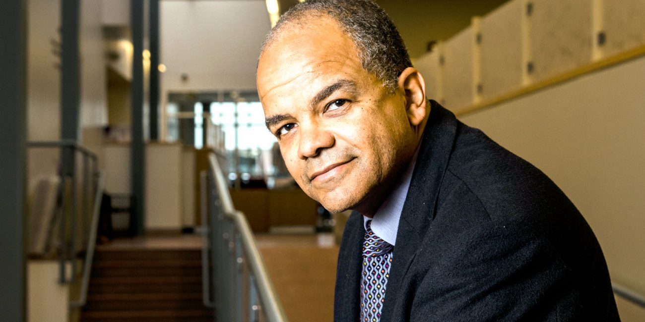 Man leaning forward on stair landing