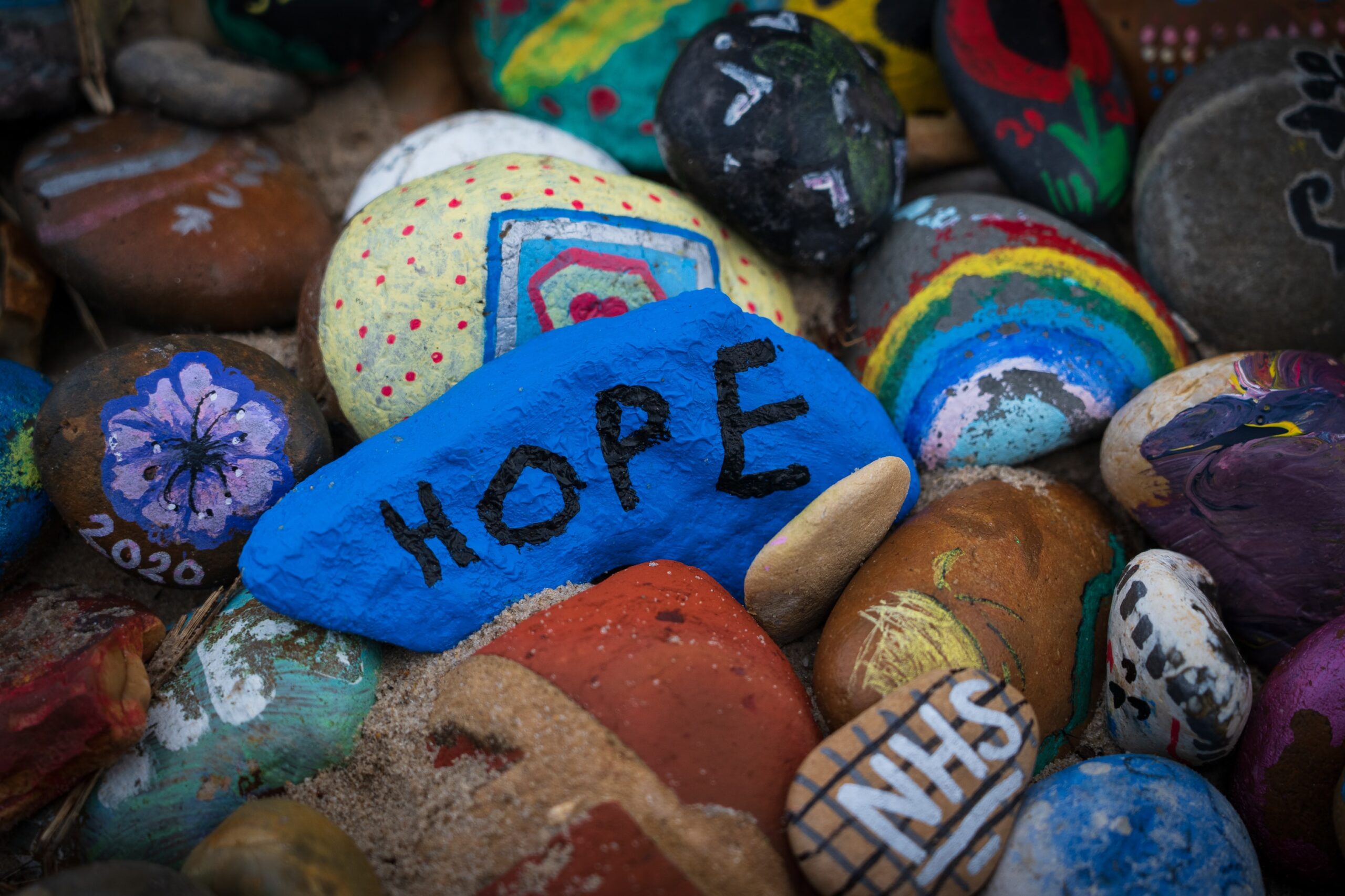 Many painted stones: hope, rainbow, NHS