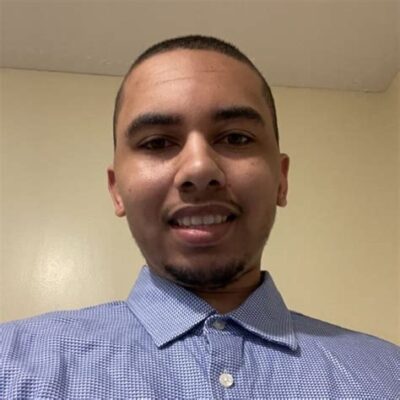 Head shot young man with short cropped hair, blue, button-up shirt