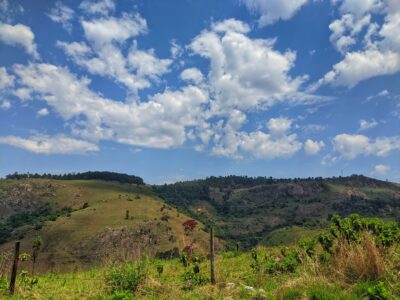 Hillside under blue sky with clounds