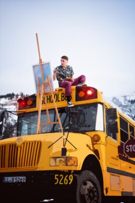 Painter sitting on school bus