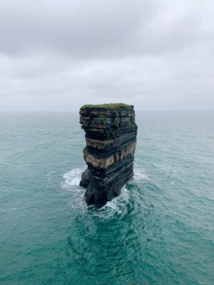 A tall rock in the ocean