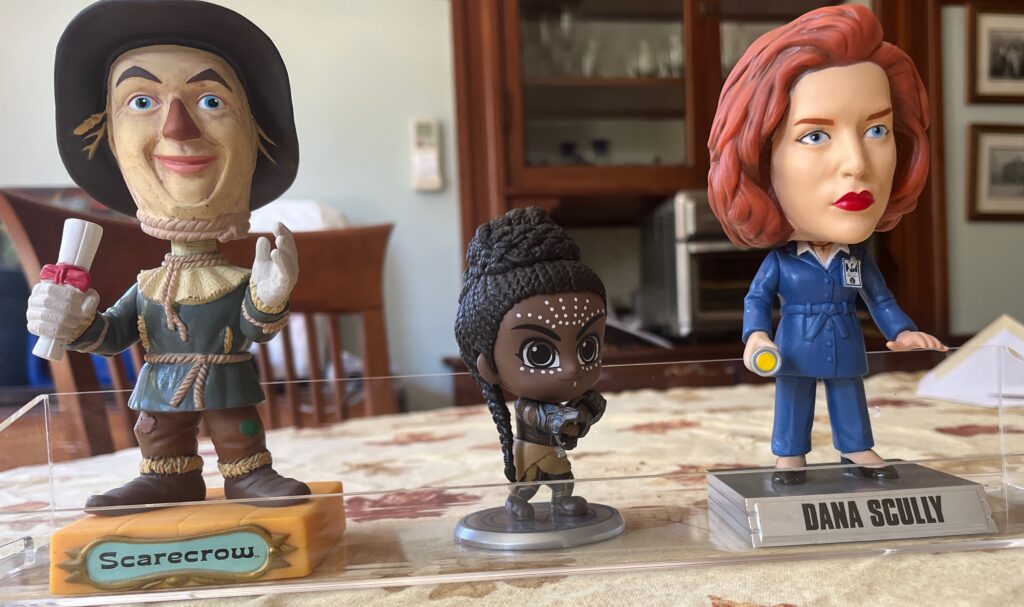 Three bobbleheads on desk