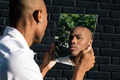 Man looking at self in mirror