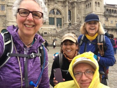 Four hikers in front of cathedral