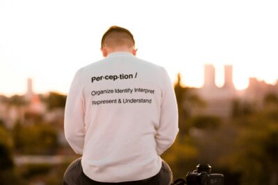 A person sitting on a bench looking at a city