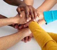 A group of people putting their hands together