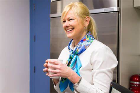 Smiling woman holding cup of coffee