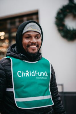 A person wearing a green and white bib