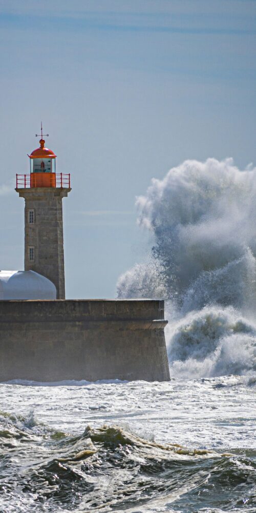 Lighthouse with waves splashing